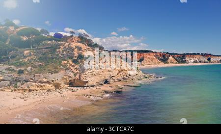 Aerial drone shot of Algarve resort historical province cliffs hills mountains exploring caves of Lagos South of Portugal travel adventure coastline Stock Photo
