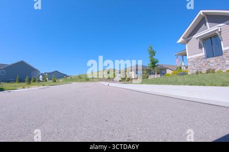 Modern homes along clean residential road Stock Photo
