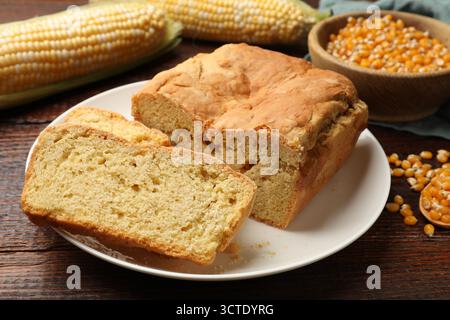 Freshly baked cornbread, cobs and seeds on wooden table, closeup Stock Photo