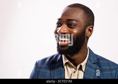 Close up portrait of happy and successful African-american businessman who is looking away and smiling. Stock Photo