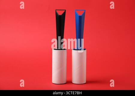 Two sticky lint rollers on red background Stock Photo