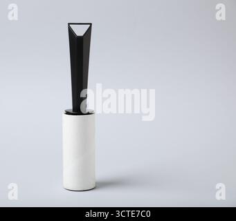 One lint roller on light grey background, space for text Stock Photo