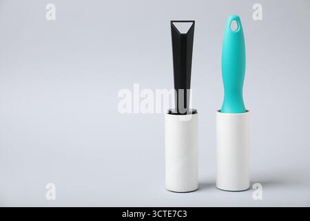 Two lint rollers on light grey background, space for text Stock Photo
