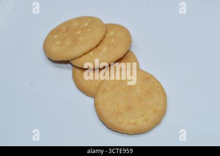 Round crunchy biscuits isolated on white background, golden brown cookies for snack or breakfast, sweet crispy crackers homemade bakery food Stock Photo
