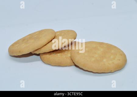 Round crunchy biscuits isolated on white background, golden brown cookies for snack or breakfast, sweet crispy crackers homemade bakery food Stock Photo