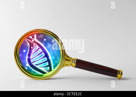 DNA spiral in magnifying glass on light background. Genetic analysis and research Stock Photo