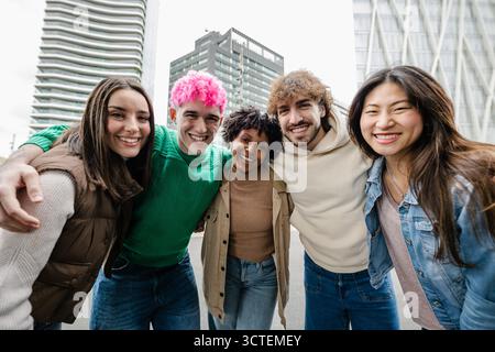 Portrait group of five young diverse friends smile at camera standing outside Stock Photo