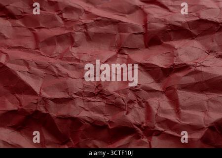 Crumpled red paper as background. Close up Stock Photo
