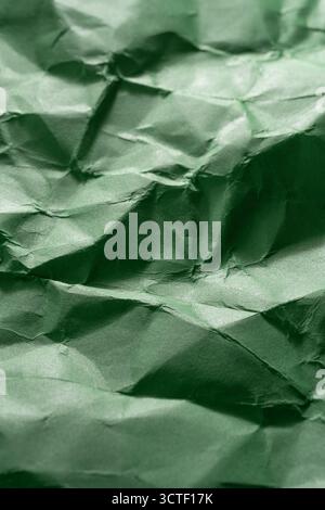 Green creased crumpled paper background grunge texture backdrop Stock Photo