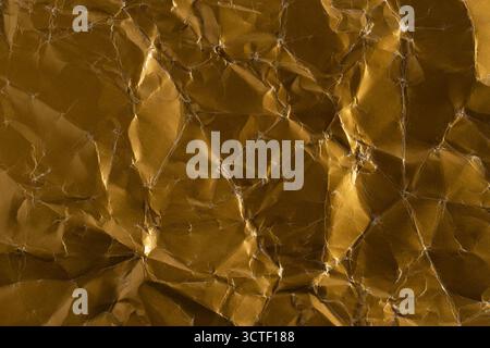 Texture crumpled golden paper. Abstract background for design Stock Photo