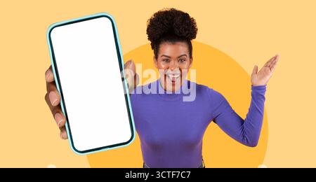 Excited Woman Holding Smartphone Against Bright Yellow Background Celebrating Her Achievement Stock Photo