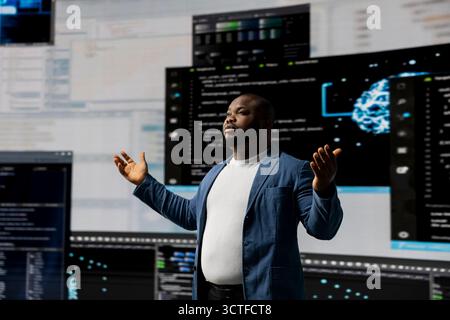 Black professional software engineer programming for tech innovation, reviewing data and binary code on the dashboard. IT specialist examining programming language code for transformation. Stock Photo
