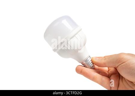 Hand holding white LED bulb on isolated white background, modern lighting. Close up view of LED bulb in hand. Energy efficient, technology Stock Photo