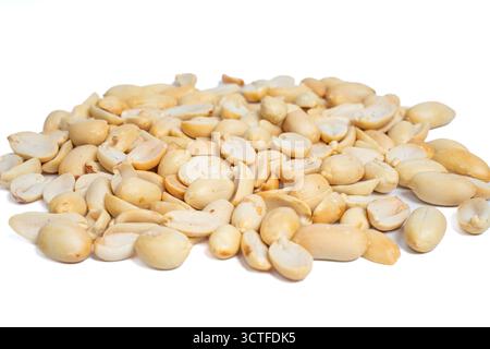 Close-up pile of roasted peeled and halved peanuts isolated on white background. Mound of shelled groundnuts for snacking and cooking Stock Photo
