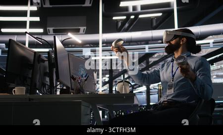 Data center developer using virtual reality technology to visualize artificial intelligence LLM neural networks. Server farm IT expert using VR headset equipment to oversee AI systems, camera A Stock Photo