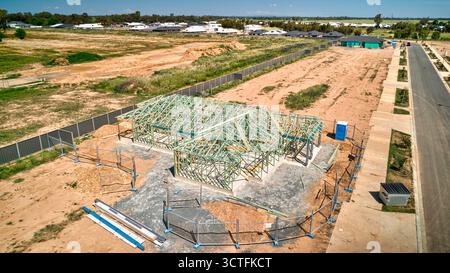 Elevated view of timber frame house under construction on cleared estate development block Stock Photo