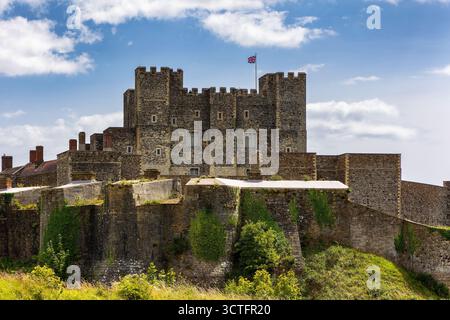 Ancient stone walls of the famous Dover Castle against a blue sky with clouds Stock Photo