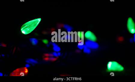 Glowing red, green, and blue RGB light bulbs isolated on black background, sharp and vibrant colors with high contrast lighting in a minimal dark setu Stock Photo