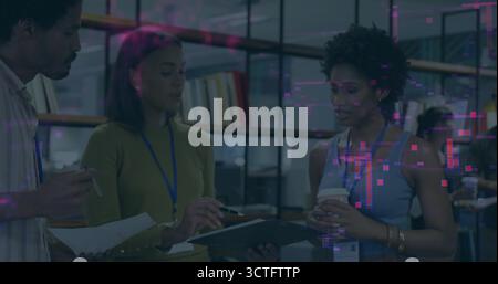 Discussing project, three colleagues collaborating in office lounge, with clipboard and coffee Stock Photo