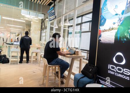 Iqos e-cigarettes sponsored smoking area in Manila airport, Philippines Stock Photo