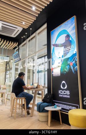 Iqos e-cigarettes sponsored smoking area in Manila airport, Philippines Stock Photo