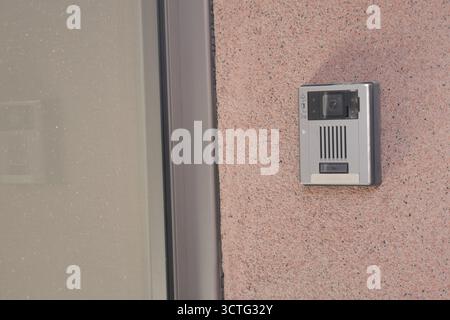Video doorbell mounted on exterior wall of home Stock Photo