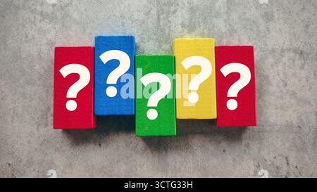 Vibrant Question Marks on Colorful Wooden Blocks on a Grey Background Representing Problem Solving and Doubt Stock Photo
