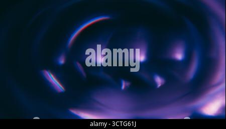 Defocused luminous twirl. Color flare. Purple neon radiant texture optical glimmer flash circle on abstract illuminated bokeh background. Stock Photo