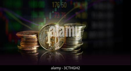 Golden coins representing cryptocurrency are displayed prominently with market data in the background, illustrating current trends and analysis. Stock Photo