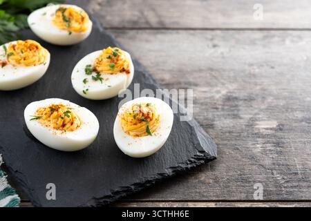 Homemade deviled eggs on wooden table Stock Photo