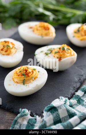 Homemade deviled eggs on wooden table Stock Photo