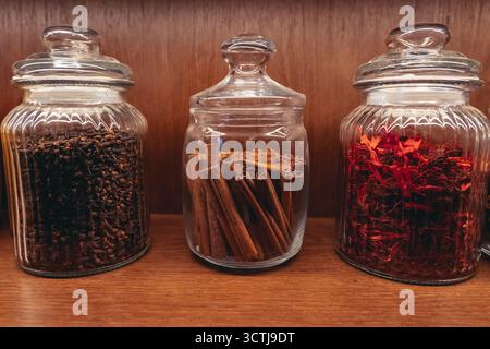 A glass jar with cinnamon quills in the kitchen Stock Photo