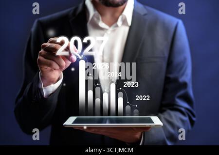 Business professional analyzing growth trends for future planning through digital graphs Stock Photo