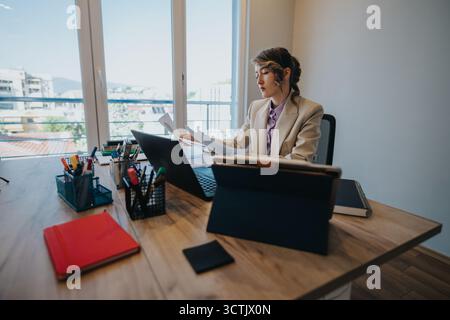 Young professional analyzing documents in an office setting during financial consultation Stock Photo