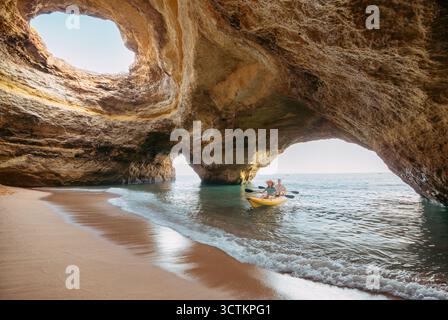 Couple on a kayak exploring the Benagil sea cave in Algarve Stock Photo