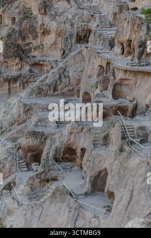 Ancient rock-cut dwellings carved into cliff face Stock Photo - Alamy