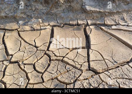 Cracked desert surface in Death Valley with dried mud textures and natural erosion detail. Stock Photo
