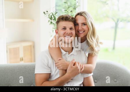 lovely young couple relaxing on the sofa at home Stock Photo