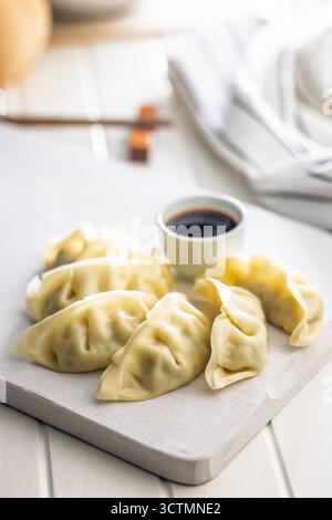 Traditional japanese gyoza dumplings on a white table. Stock Photo