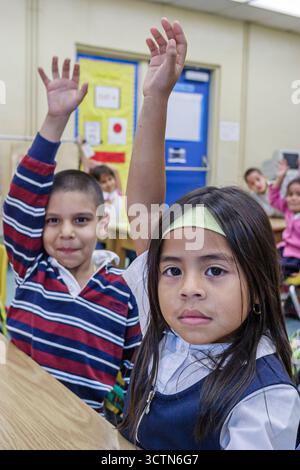 Miami Florida,Overtown,Frederick Douglass Elementary School,Hispanic student students boy boys girl girls,American Americans class classroom raised ha Stock Photo