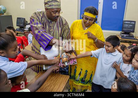 Miami Florida,Overtown,Frederick Douglass Elementary School,teacher man male dressed outfit,literary costume reading book fictional character,Hispanic Stock Photo