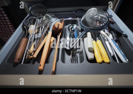Kitchen drawer with various cooking utensils and tools Stock Photo