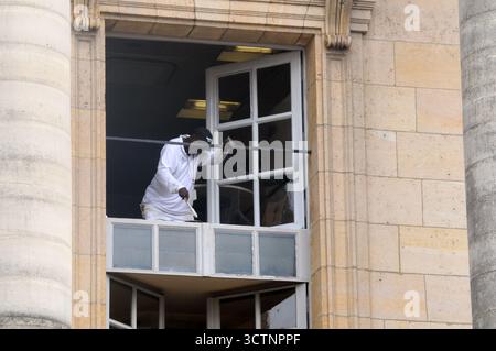 Workers painting windws at he Chateau de Versailles (Palace of Versailles), near Paris, France. Stock Photo