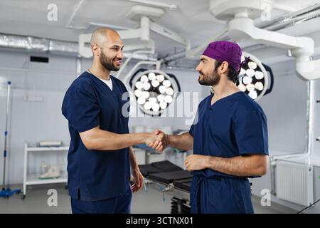 Surgeons Handshake in Operating Room Stock Photo