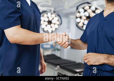 Surgeons Handshake in Operating Room Stock Photo