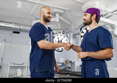 Surgeons Handshake in Operating Room Stock Photo
