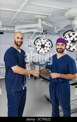 Surgeons Handshake in Operating Room Stock Photo