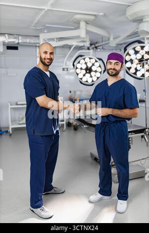 Surgeons Handshake in Operating Room Stock Photo