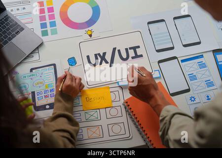 UX UI Design Process. Team members sketching app layouts and features. Stock Photo