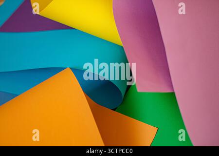 Abstract colorful paper sheets in overlapping curves and layers. Close-up abstract composition of vibrant colorful paper sheets. Arranged in overlappi Stock Photo